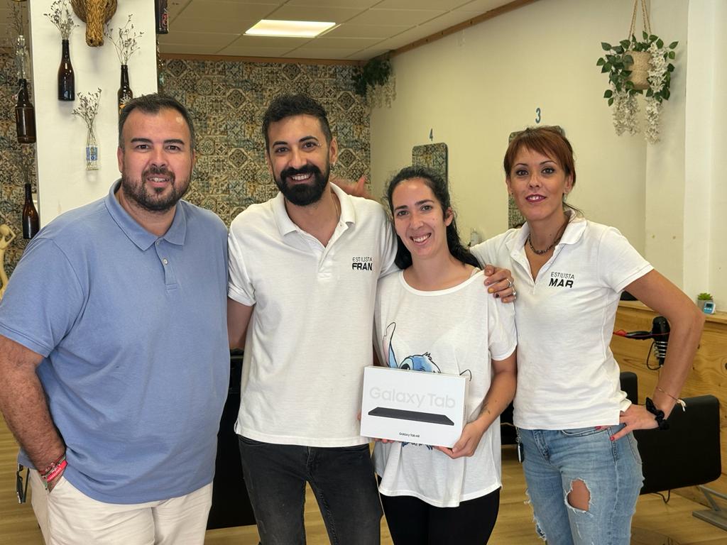 El regidor de Comerç en el lliurament d'una de les tauletes a una de les guanyadores en un comerç de Paterna